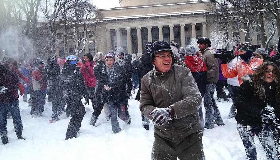 MIT President L. Rafael Reif, center, joined the snowball fight on Killian Court.