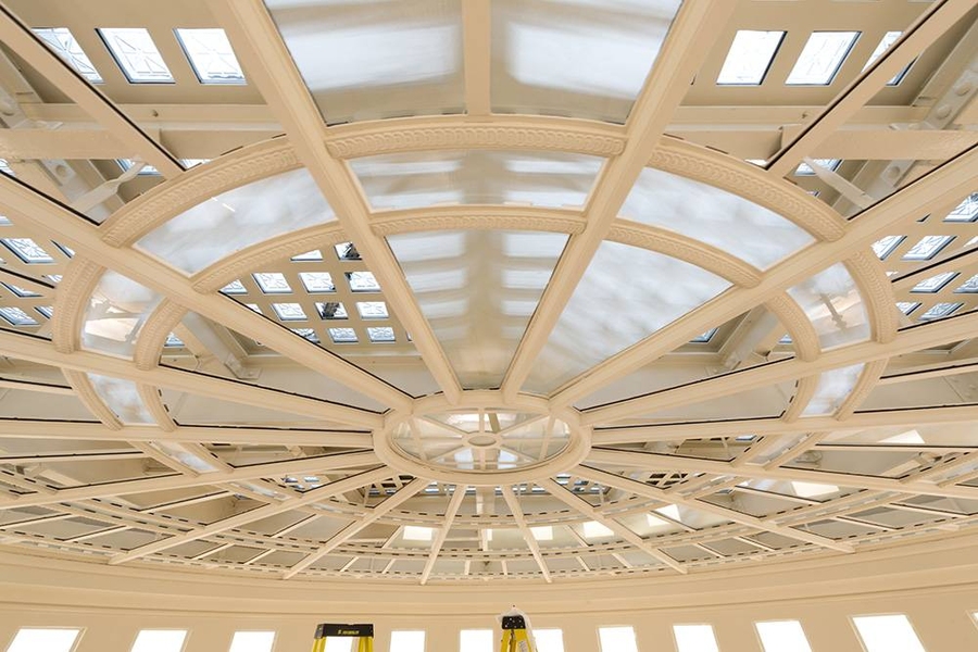 Installation of translucent glass lens below the skylight on the ceiling of the Barker Library rotunda.