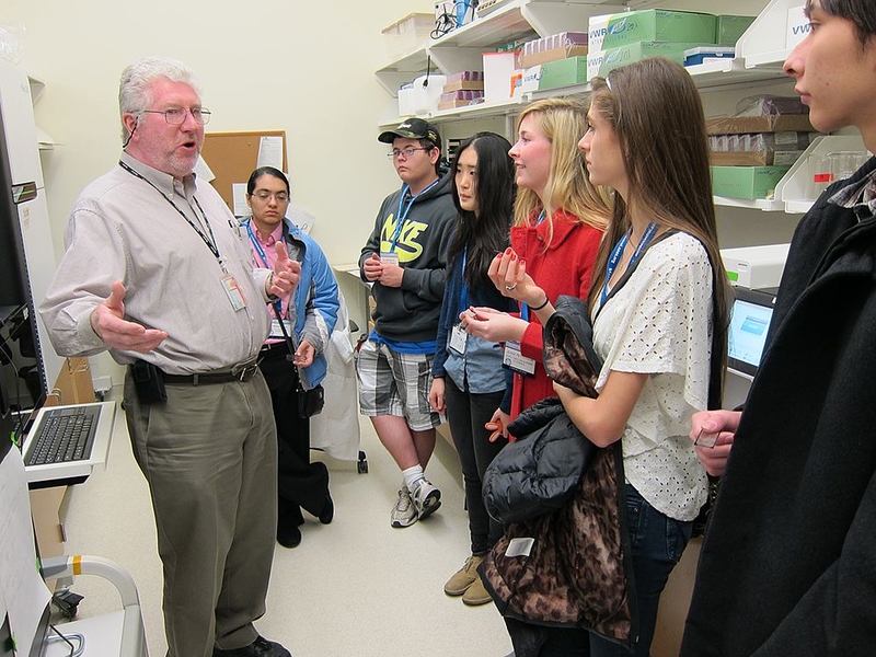 Richard Cook, a research scientist in the Koch Institute's Swanson Biotechnology Center, shows students around the Biopolymer and Proteomics Core Facility.