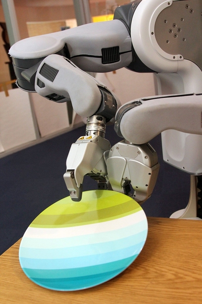 When the PR2 sets a plate on a table, the plate may stick to the robot's rubber gripper. Annie Holladay's algorithm enables the PR2 to position its second gripper to prevent the plate from sliding off the table.
