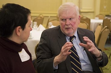 Victor McElheny, founding director of the Knight fellowships, talks with a former fellow during the 30th anniversary celebration.