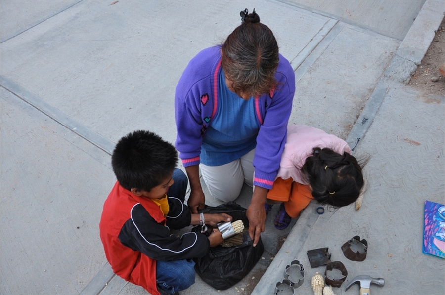 Residents using corn sheller in El Gusano, Mexico.
