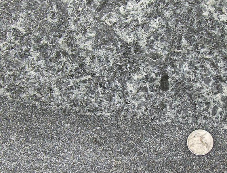 Close up of a rock intrusion in Virginia, showing coarse grain segregations analyzed for the presence of the mineral zircon, which can be dated with very high precision.
