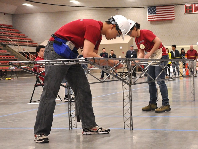 Grant Iwamoto (left) and Maria Tou, co-captain of the MIT Steel Bridge team, constructed the bridge during the regional competition at MIT. 
