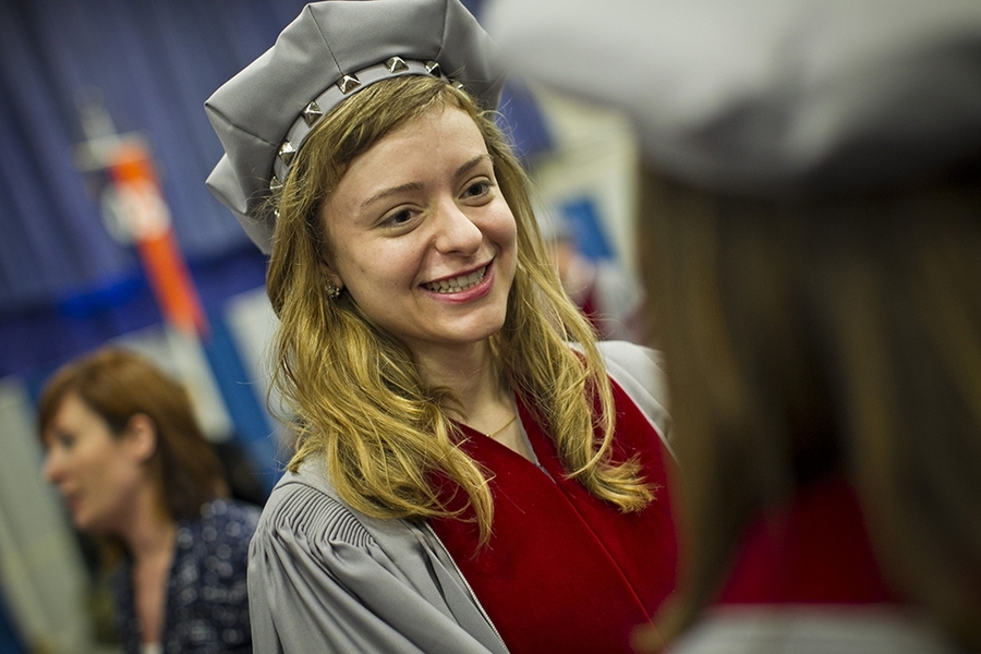 The doctoral hooding ceremony is traditionally held a day before Commencement.