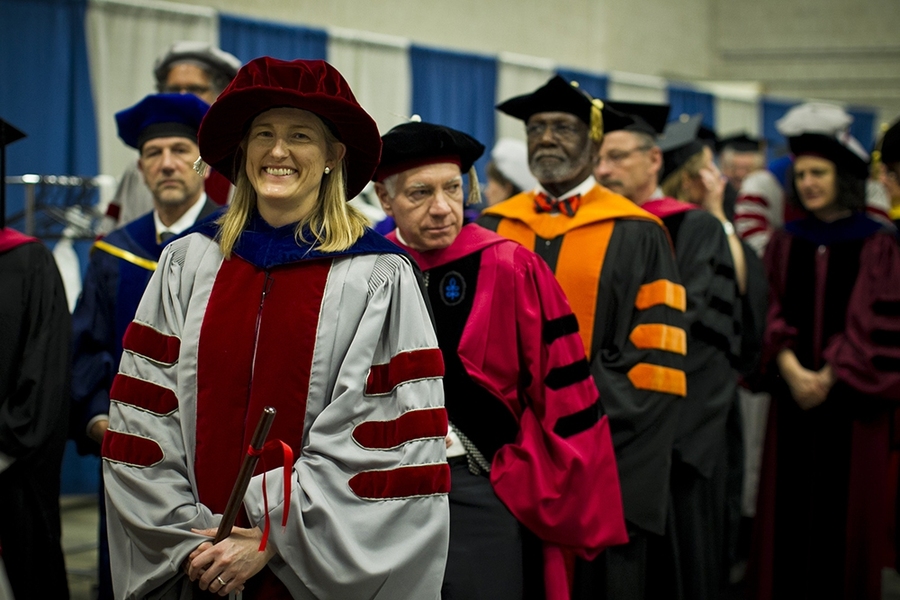 The doctoral hooding ceremony is traditionally held a day before Commencement.