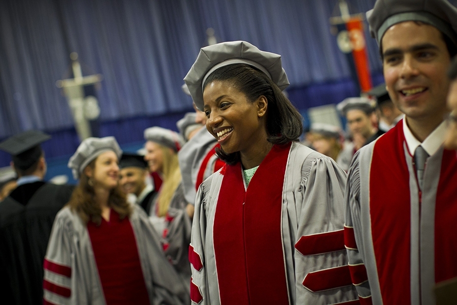 The doctoral hooding ceremony is traditionally held a day before Commencement.