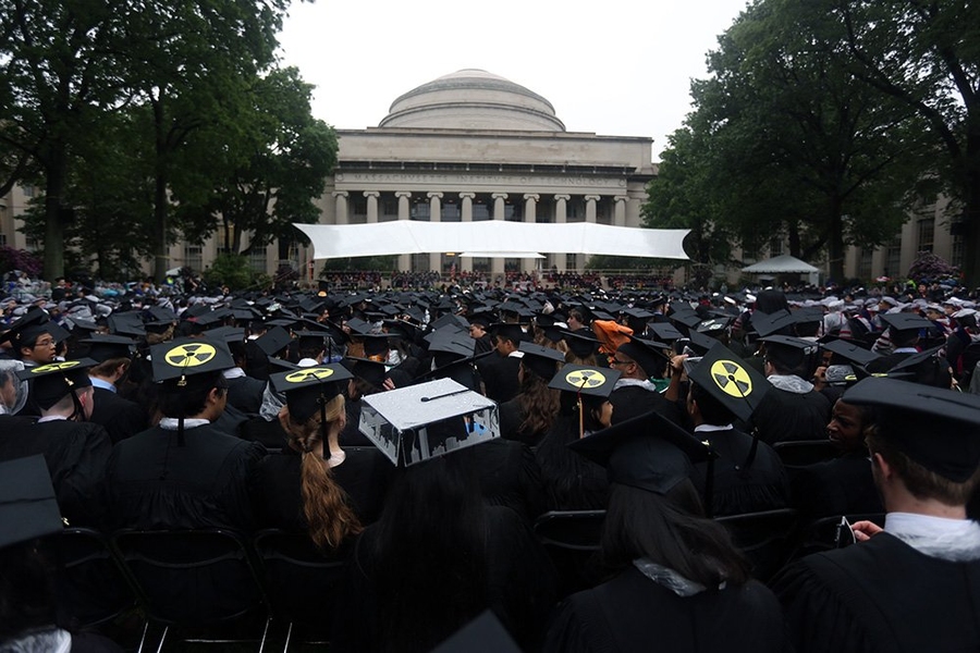 Graduates, and their well-designed mortarboards, fill Killian Court.