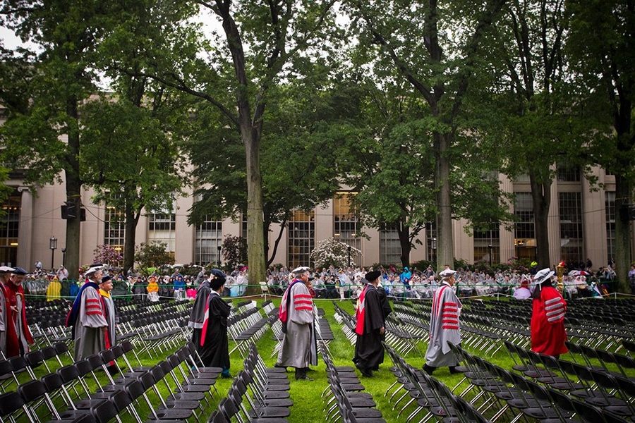 MIT administrators and faculty make their way to the stage.