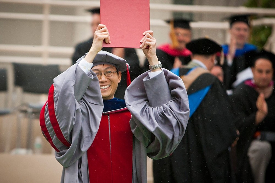 The final graduate receives his diploma.