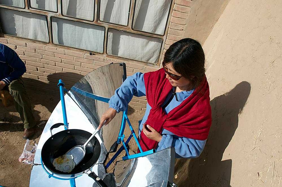 Using the SolSource, a Mongolian woman cooks breakfast for a family of five.