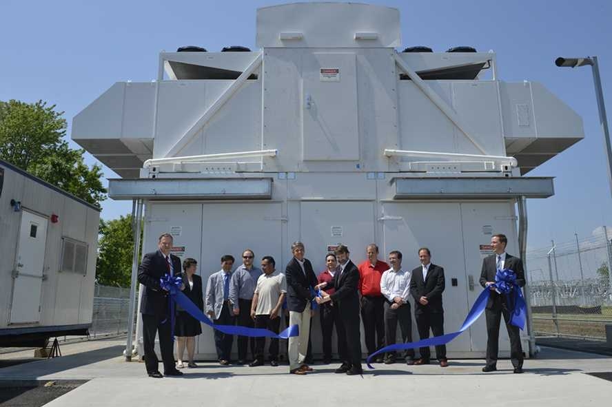 Dr. Eric D. Evans, director of Lincoln Laboratory (center left), and Dr. Jeremy Kepner, senior staff in the Computing and Analytics Group and lead of the data center project, cut the ribbon on May 31 to inaugurate the lab's new data center in Holyoke, Mass.