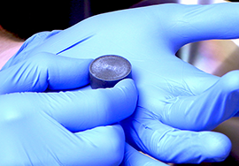 Aimon holds a ceramic pellet that will be ablated, or vaporized, by a laser in a pulsed laser deposition chamber to form single crystal complex metal oxides, such as cobalt iron oxide or bismuth iron oxide. 