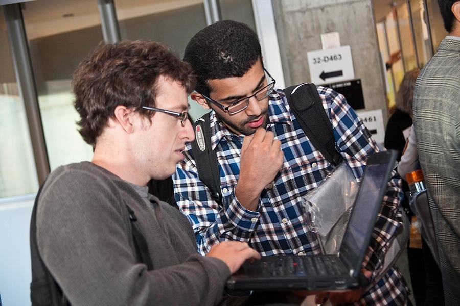 SuperUROP students Chase Lambert and Abdul Alfozan checked the new SuperUROP brochure at the kickoff reception held for students, their industry mentors and faculty advisors and guests on Sept. 26 in the MIT Stata R&D area.