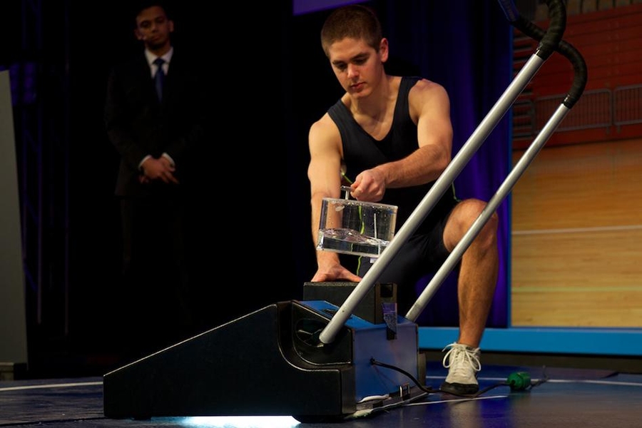 John Kongoletos demonstrates San-X, a device that uses steam and ultraviolet light to clean and sterilize mats used for wrestling matches.
