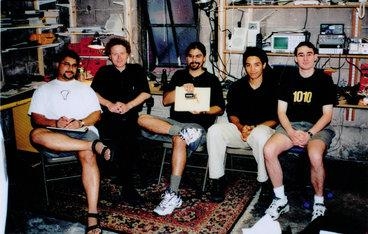 ThingMagic co-founders (from left) Ravi Pappu, Bernd Schoner, Rehmi Post, Yael Maguire, and Matt Reynolds, in ThingMagic's first office — a garage in Somerville — in 2000.