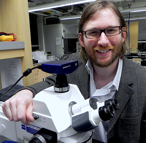 Visiting graduate student Ryan Oliver with a microscope. Oliver's projects under Associate Professor of Mechanical Engineering A. John Hart include the Robofurnace, an automated system for making carbon nanotube forests and studying their growth, and high-throughput manufacturing of polymer microstructures for biosensing. 