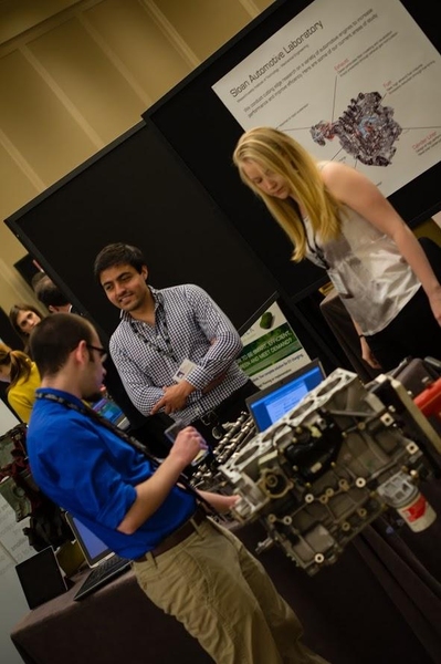 Students from MIT's Sloan Automotive Laboratory demonstrate their projects to improve car engines.