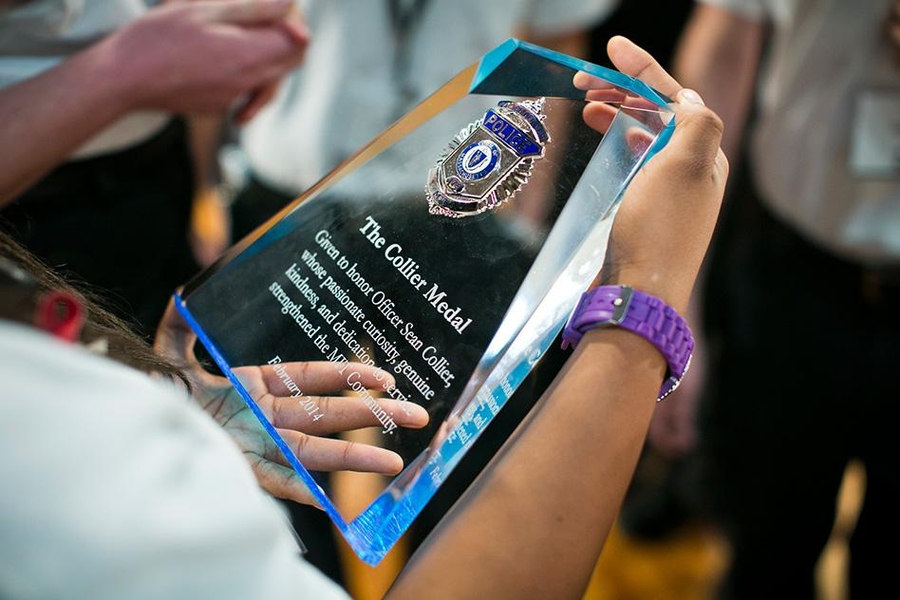 One of this year's recipients, the members of MIT's student-run Emergency Medical Services, examines the plaque presented to each of them for the first annual Collier Medal.