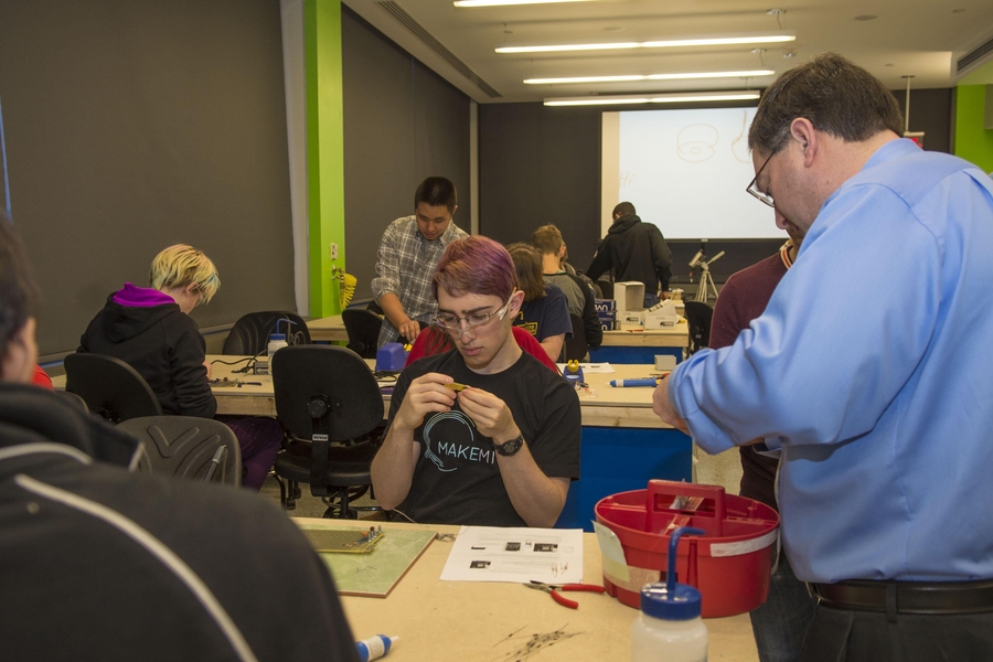 Professor Steve Leeb (right) guides students in 6.115 lab in the new EDS lab space.