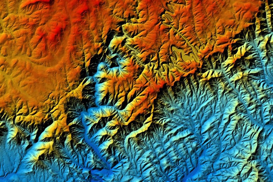 A shaded relief map of part of the Dan River basin in Virginia, with blues indicating lower elevations and reds indicating higher elevations. The Blue Ridge Escarpment, which crosses the image from lower left to upper right, is migrating northwest as river basins on the southeastern side erode faster than those to the northwest.