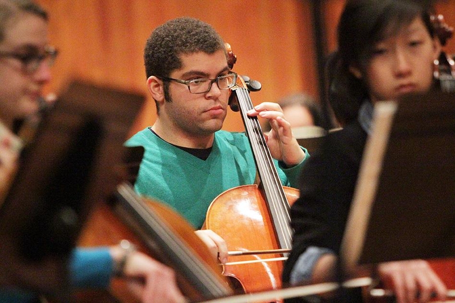 Nathan Kipniss playing cello in the MIT Symphony Orchestra (MITSO)