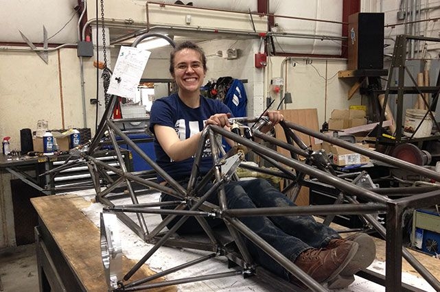 Jacqueline Sly, '14, sitting in the steel frame of the new electric Formula SAE car. 