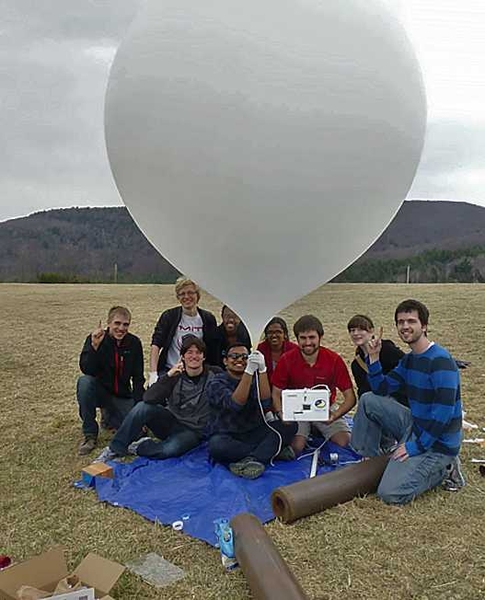 MIT AeroAstro Global Space Balloon team members pose with their balloon just prior to launch. From left: Devon Jedamski; (front) Eddie Obropta, Gaurav Mukherjee; (rear) Johannes Norheim, Janelle Wellons, and team guest Shikha Chaganti; Forrest Meyen, Sherrie Hall, and Duncan Miller. 