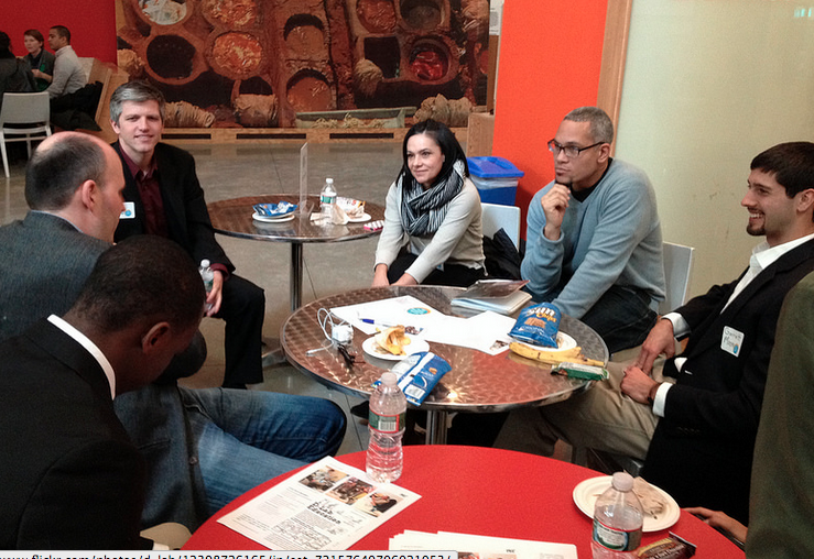 D-Lab associate director Kofi Taha (second from right) speaks with industry representatives and conference participants at a Scaling Development Ventures networking event in February.