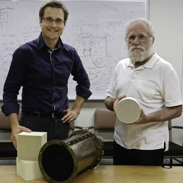 Alexander Sappok '09 (left) and Leslie Bromberg, inventors of the RF-DPF&trade; diesel particulate filter (DPF) sensor, hold ceramic particulate filters, which are standard on all 2007 and newer diesel engines to reduce soot emissions. The RF-DPF&trade; sensor enables more efficient engine operation with the filters. 