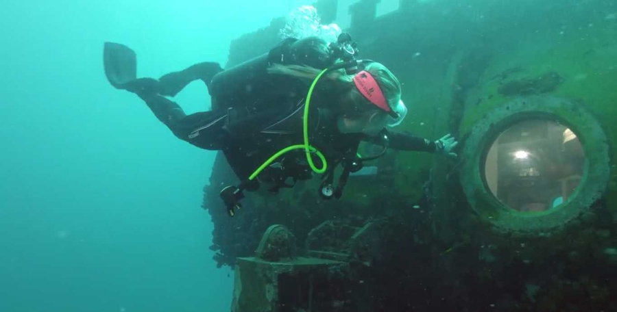 While on an undersea mission off Florida, Grace Young '14 marked her June 6 graduation from MIT by flipping her "Brass Rat" class ring along with her classmates.