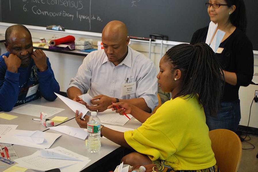 Teams build airplane models as part of a workshop.