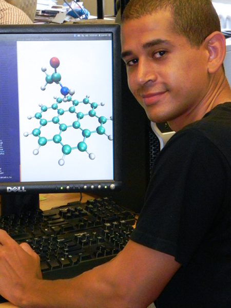 Gabriel Denham undertook a computational analysis of adding an amide found in nature to graphene, to coax an electronic bandgap in graphene. The image on the computer screen shows a flake of graphene with an amide molecule above it displayed through the ORCA finite software program. 