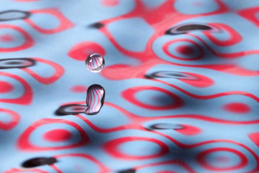 Close-ups of an experiment conducted by John Bush and his student Daniel Harris, in which a bouncing droplet of fluid was propelled across a fluid bath by waves it generated.