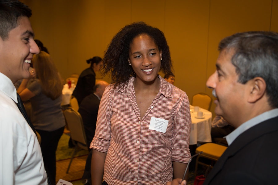 MIT freshmen Omar Gonzalez and Chantal Acacio, both 2013 alumni of E2@MIT, chat with Mehrotra.