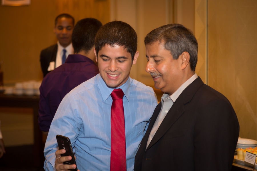 MIT senior Michael Rodriguez, a 2010 MITES alumnus and senior in electrical engineering and computer science at MIT, shows a project to Mehrotra. Asked if engineers can become CEOs, Mehrotra told Rodriguez, “I believe engineers make the best CEOs, particularly in technology, because they understand the challenges of driving innovation.”