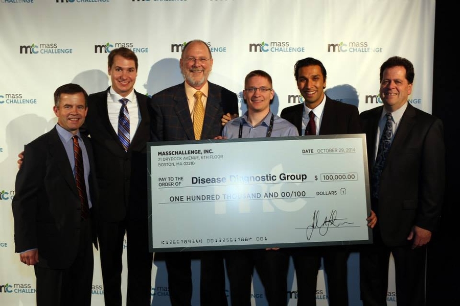 MIT PhD student John R. Lewandowski (fourth from left) accepts a $100,000 grand prize with the rest of his team at Wednesday night's MassChallenge awards ceremony.