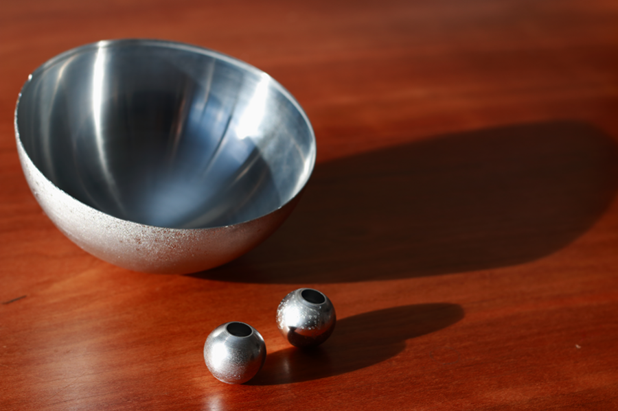 Nanocrystalline-aluminum alloy hollow spheres and hemisphere are made by electroplating metal onto an arbor, or mandrel, and then mechanically and chemically separating them. 