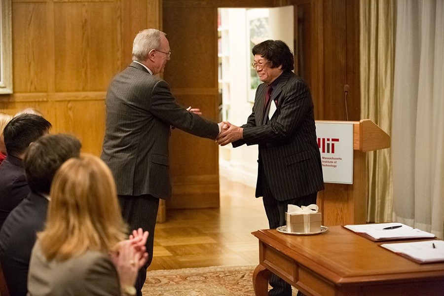 MIT President L. Rafael Reif shakes hands with Samuel Tak Lee at the signing ceremony formalizing Lee's gift to MIT. The gift will create a new Samuel Tak Lee MIT Real Estate Entrepreneurship Lab and result in the renaming of MIT's Building 9 as the Samuel Tak Lee Building.