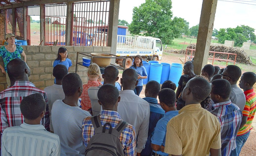Xing, with teammate and MIT alumna Coyin Oh '14 and faculty supervisor Susan Murcott, demonstrating their system to fourth-year students from the University of Development Studies at Tamale, Ghana.