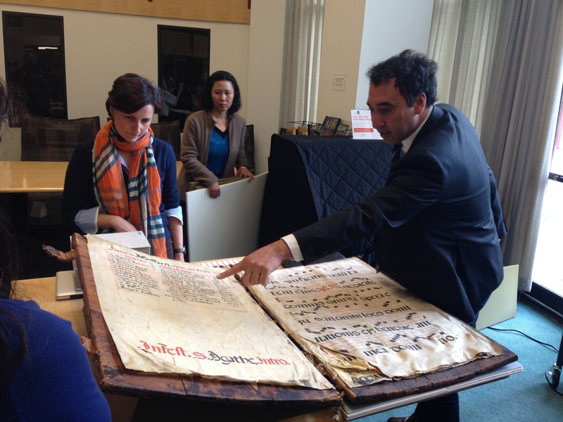 Theresa Zammit Lupi (left) and Michael Cuthbert (right) examine the Glaser Codex at the Lewis Music Library.
