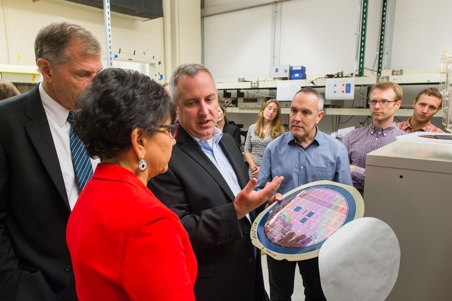 In MIT’s Research Laboratory of Electronics (RLE), Associate Professor MIchael Watts describes his photonics research into controlling energy consumption by moving data using light instead of electricity. Also pictured are (from left) Pritzker's husband, Bryan Traubert; Associate Professor Krystyn Van Vliet; Professor Yoel Fink, who is director of the RLE; and postdoc Ben Moss and graduate stude...