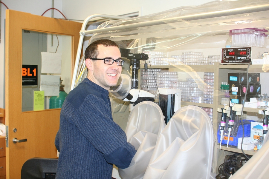 Graduate student Michael Funk working in an anaerobic chamber in the Drennan Lab.