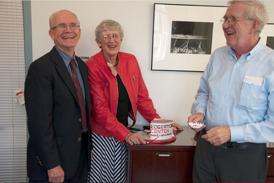 With J. Kim Vandiver (left) and Candace Forbes (center) looking on, Bert Forbes '66 holds a 3-D printed milk drop modeled after Doc Edgerton’s milk drop photo, made in the Edgerton Center Student Shop.