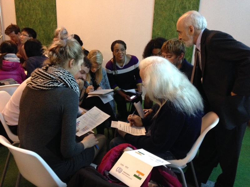 MIT Sloan School of Management Professor John Sterman assists “delegates” representing India in the World Climate role-play negotiation. 