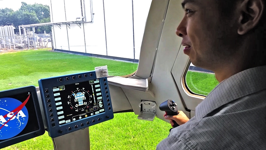 At the controls, Sydney Do maneuvers the NASA Mars rover prototype around the grounds of the Johnson Space Center.