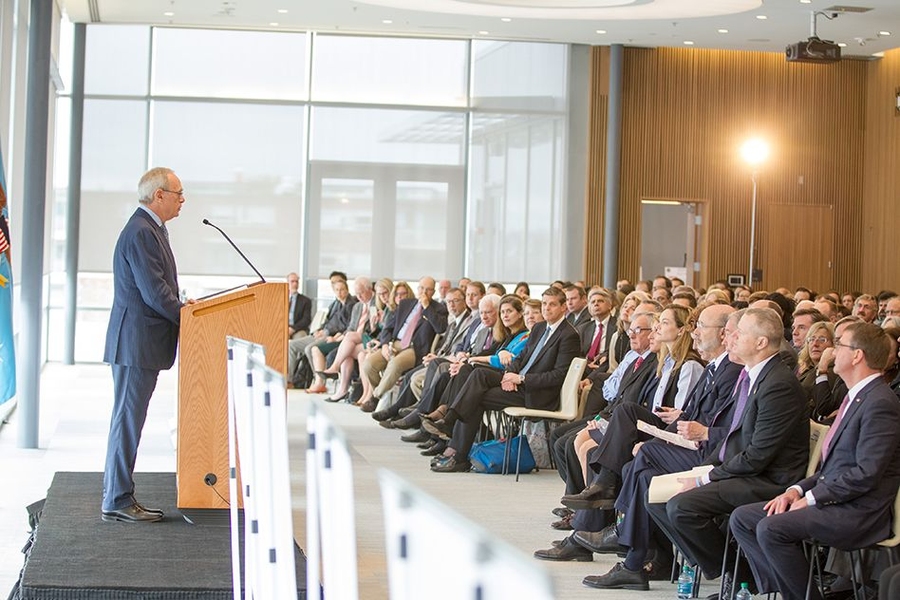 Rafael Reif addresses the crowd assembled in the Samberg Conference Center at MIT. The event announced that an independent nonprofit founded by MIT has been selected to run a new $317 million public-private partnership designed to accelerate innovation in high-tech, U.S.-based manufacturing involving fibers and textiles.
