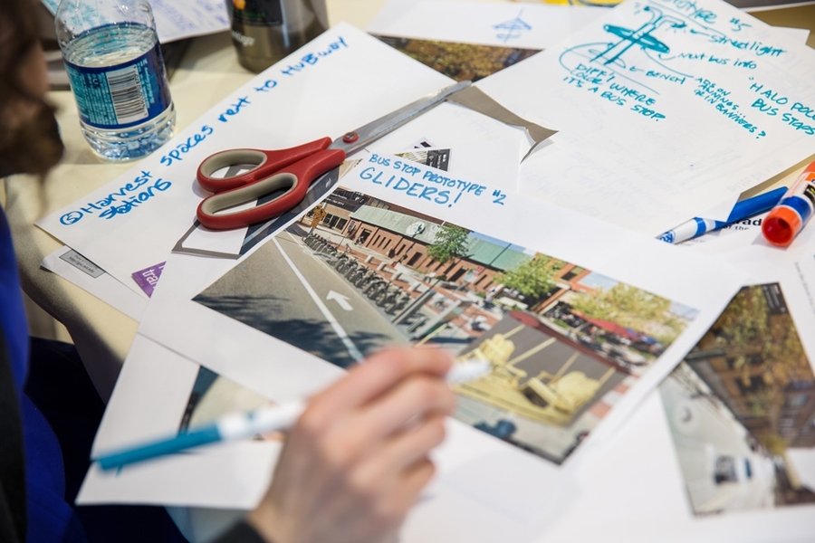 As part of the "Serve-a-thon" hackathon, MIT teams created innovative solutions to infrastructure concerns facing Cambridge, including tree-friendly sidewalks, street redesigns, parking solutions, and bus shelter redesigns. Shown here is a team's idea for a glider swing set near Hubway bike stations. 
