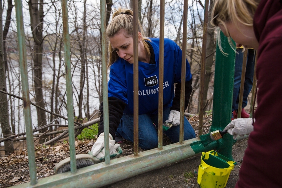 MIT community members paint a railing along roads near MIT's campus as part of the inaugural Together in Service Day, held on Tuesday, which included dozens of volunteer opportunities across the region and beyond. 