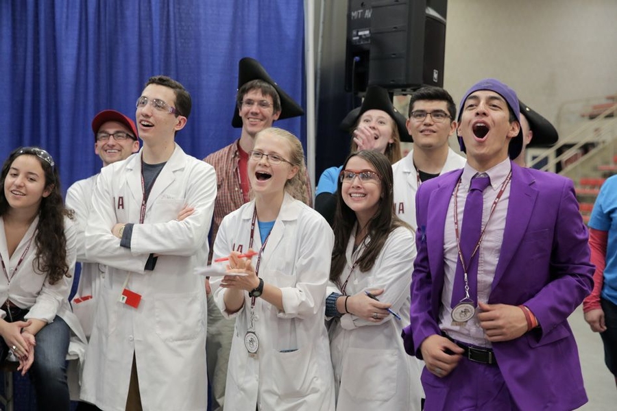 A group of mentors cheer on the class.
